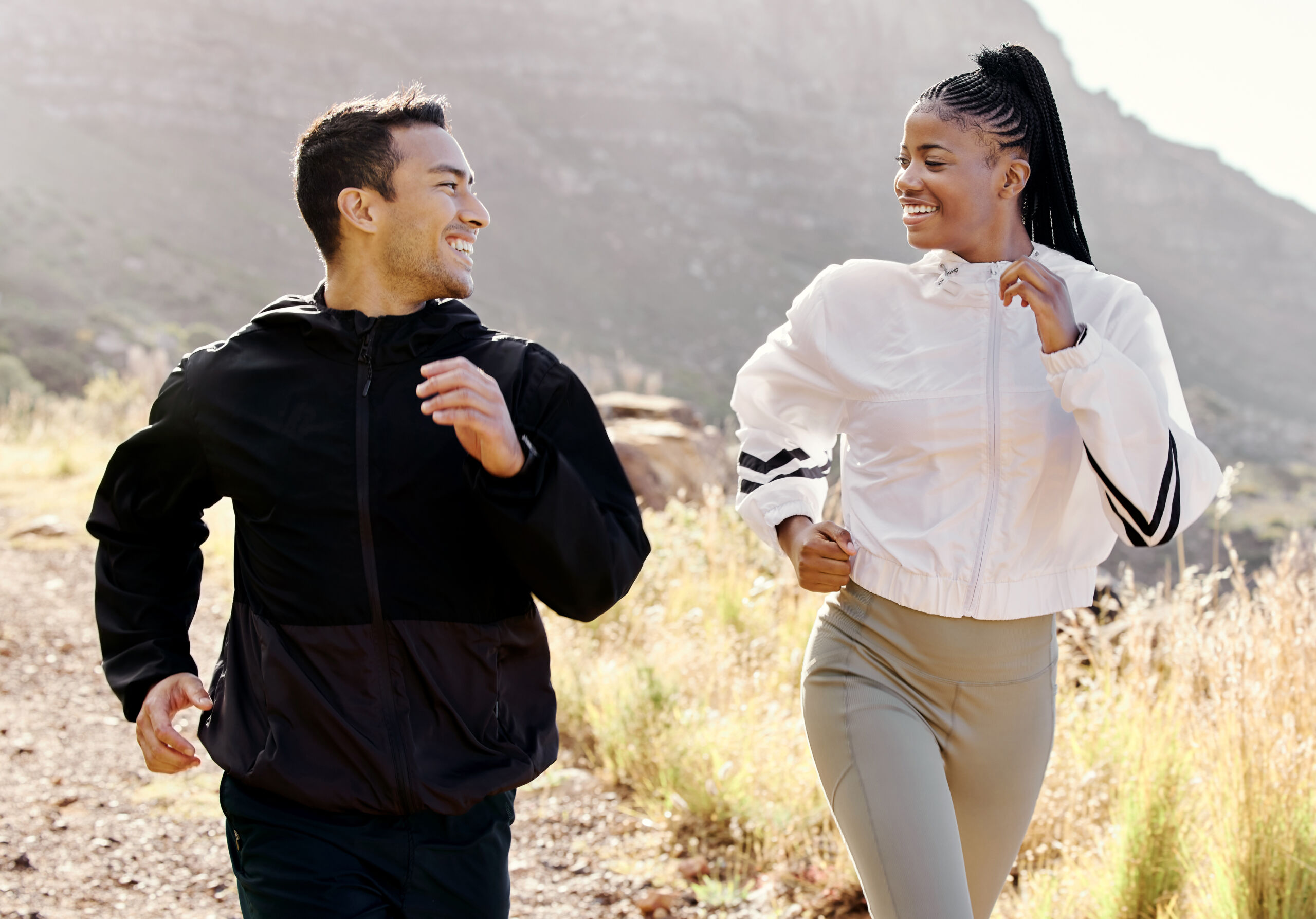 Couple running outdoors on a hiking trail